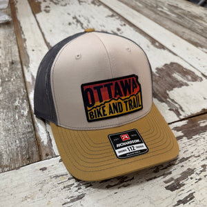 First In Apparel Shop Merch Cream Ottawa Bike and Trail Logo Trucker Hat
